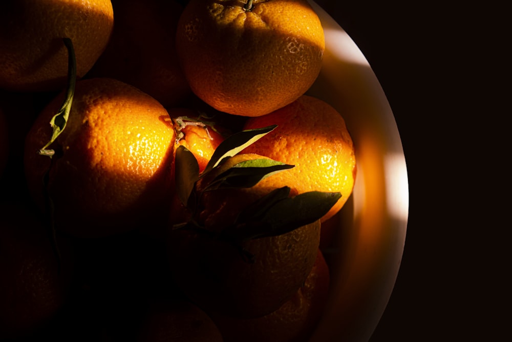 orange fruit in brown ceramic bowl