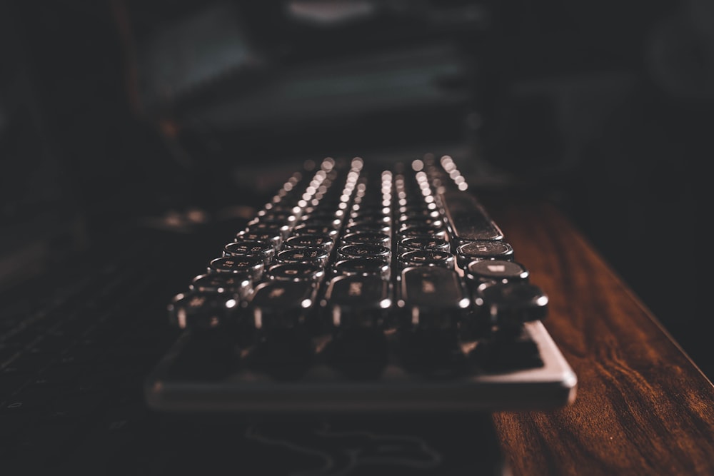 teclado preto do computador na mesa de madeira marrom