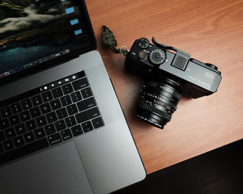 black nikon dslr camera on macbook pro