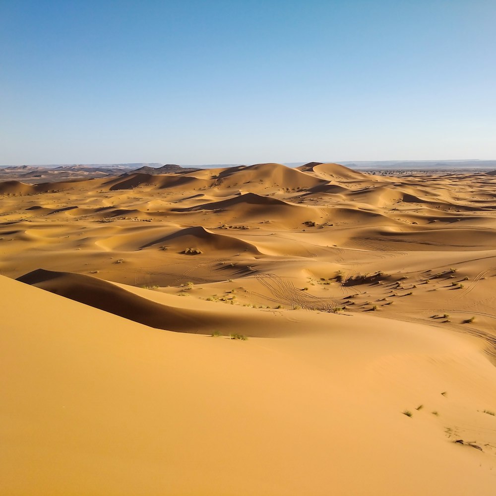 white sand under blue sky during daytime