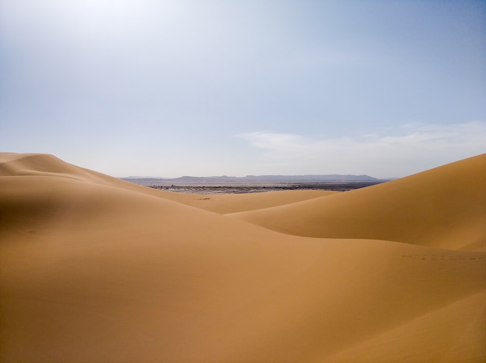 brown sand under blue sky during daytime