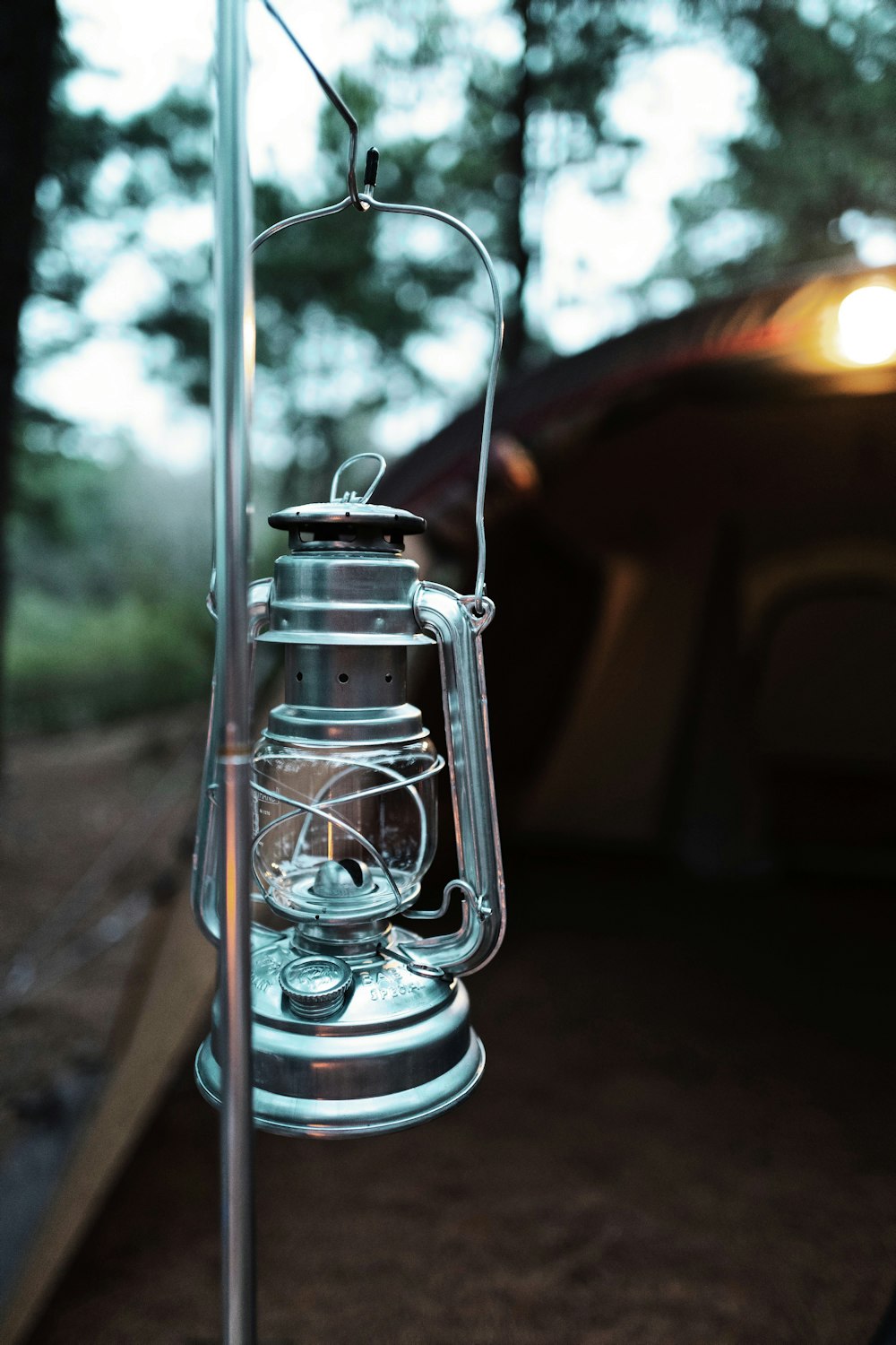 silver lantern lamp on gray concrete floor