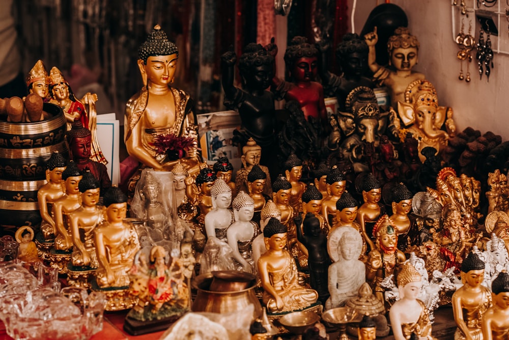 gold buddha figurine on table