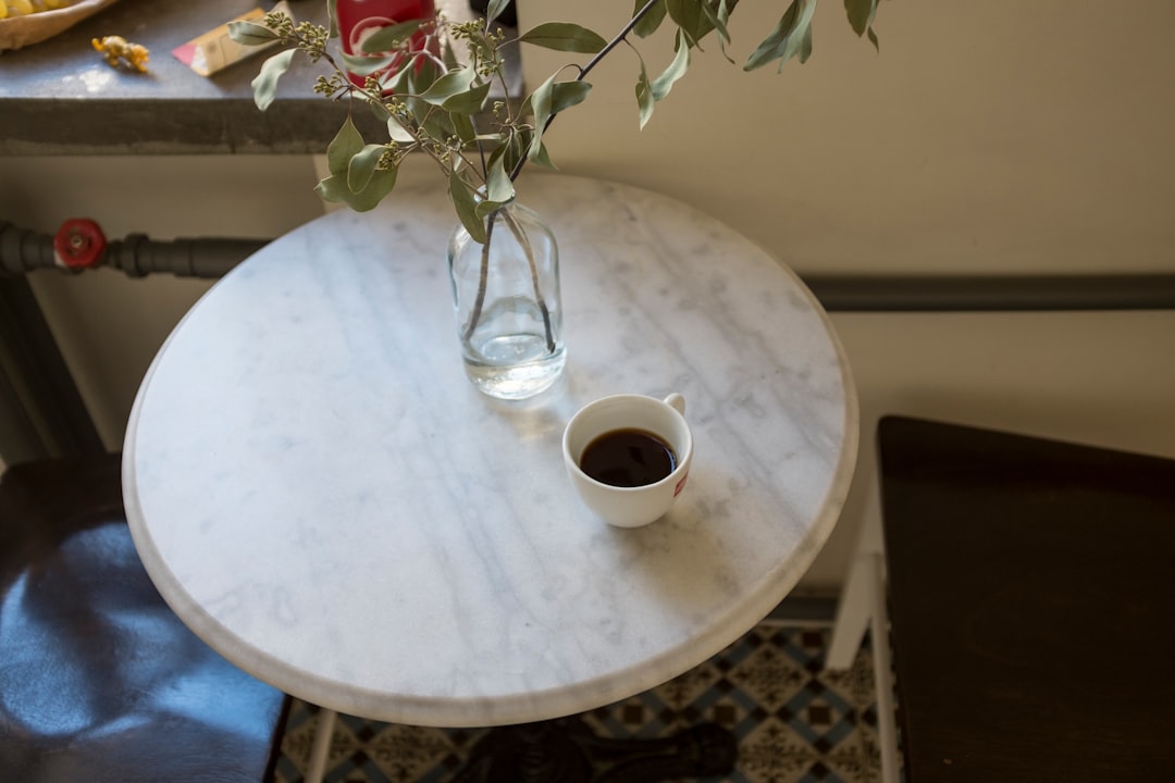 white ceramic mug on white round table