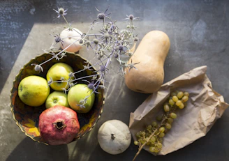 green and yellow apples on brown wooden table