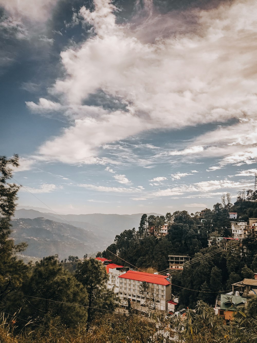 white and red house on top of mountain during daytime