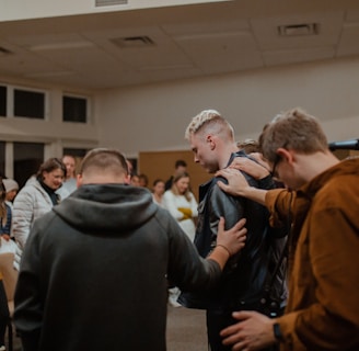 people in black and brown jackets standing in front of people