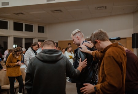 people in black and brown jackets standing in front of people