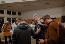 people in black and brown jackets standing in front of people