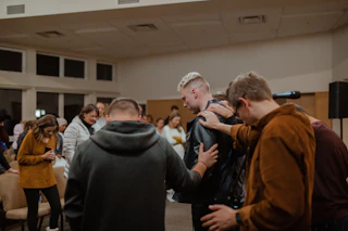 people in black and brown jackets standing in front of people