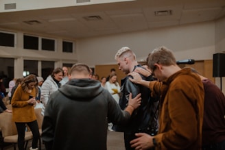 people in black and brown jackets standing in front of people