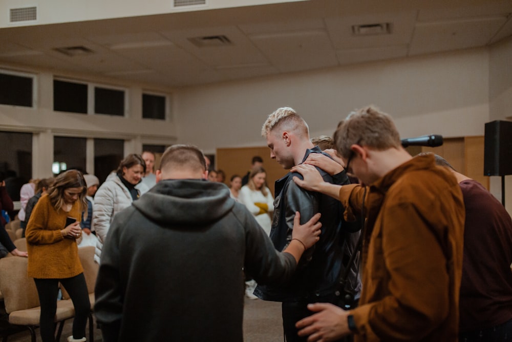 people in black and brown jackets standing in front of people