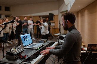 man in black long sleeve shirt using macbook pro