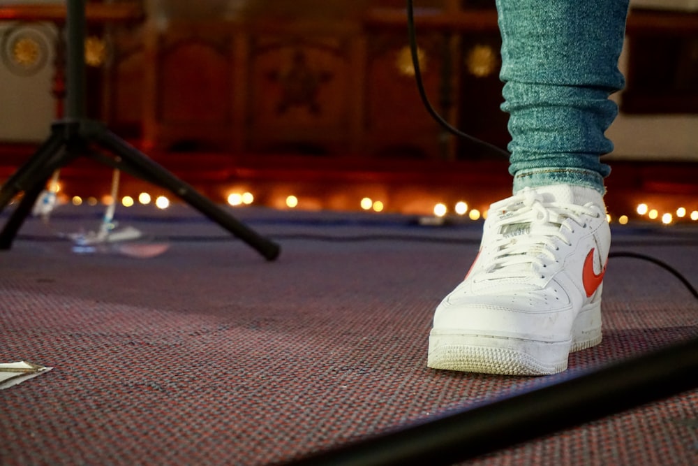 person in white nike air force 1 high