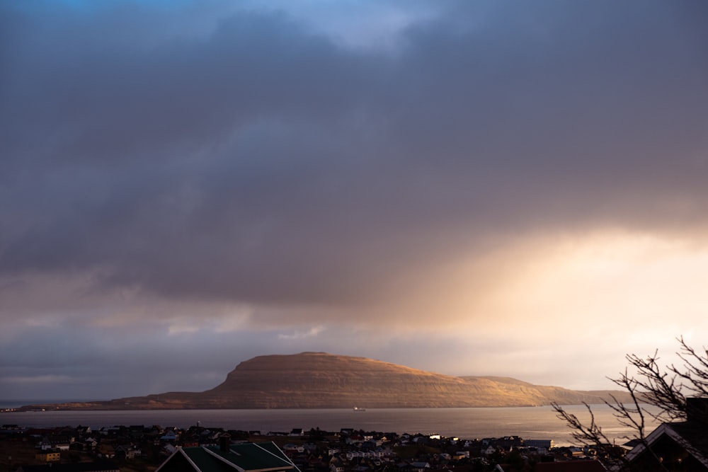 white and brown mountain under white clouds during daytime