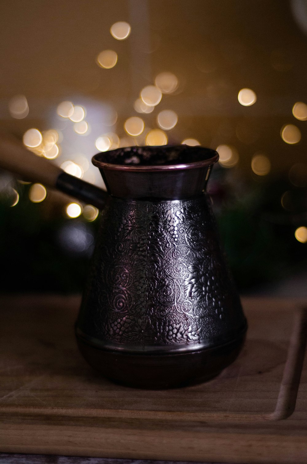 black ceramic pot on brown wooden table