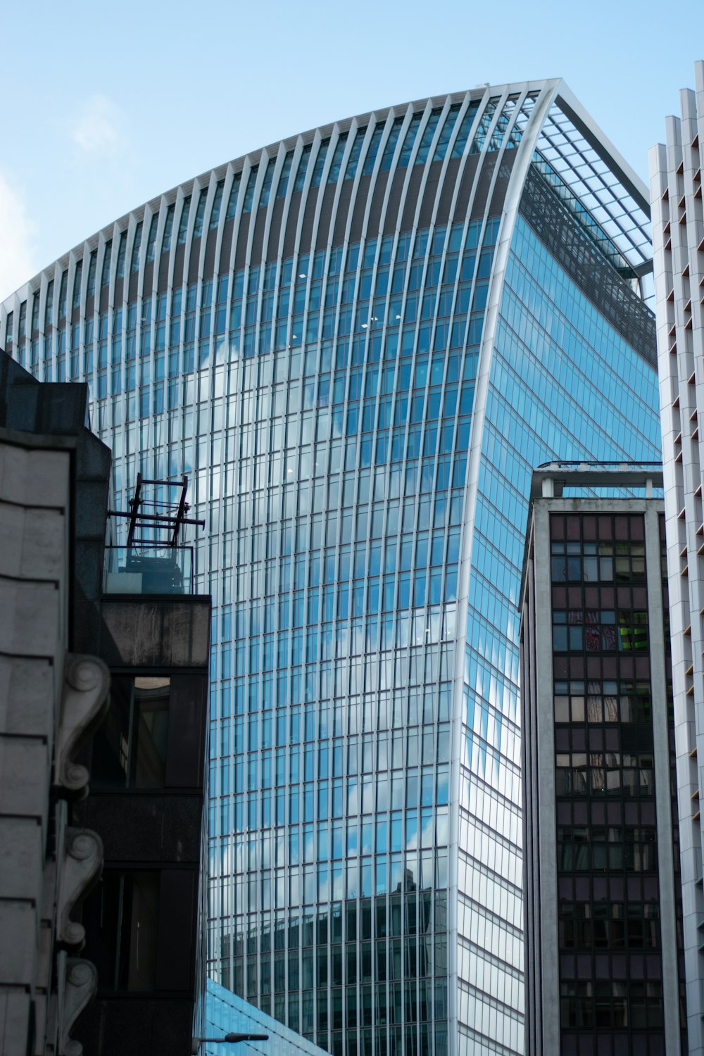 blue and white glass walled high rise building