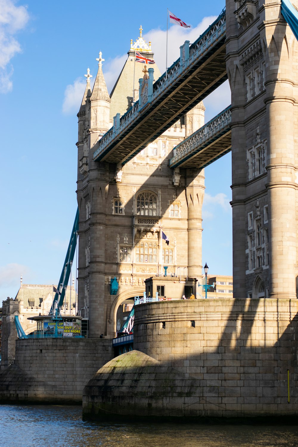 brown concrete bridge under blue sky during daytime