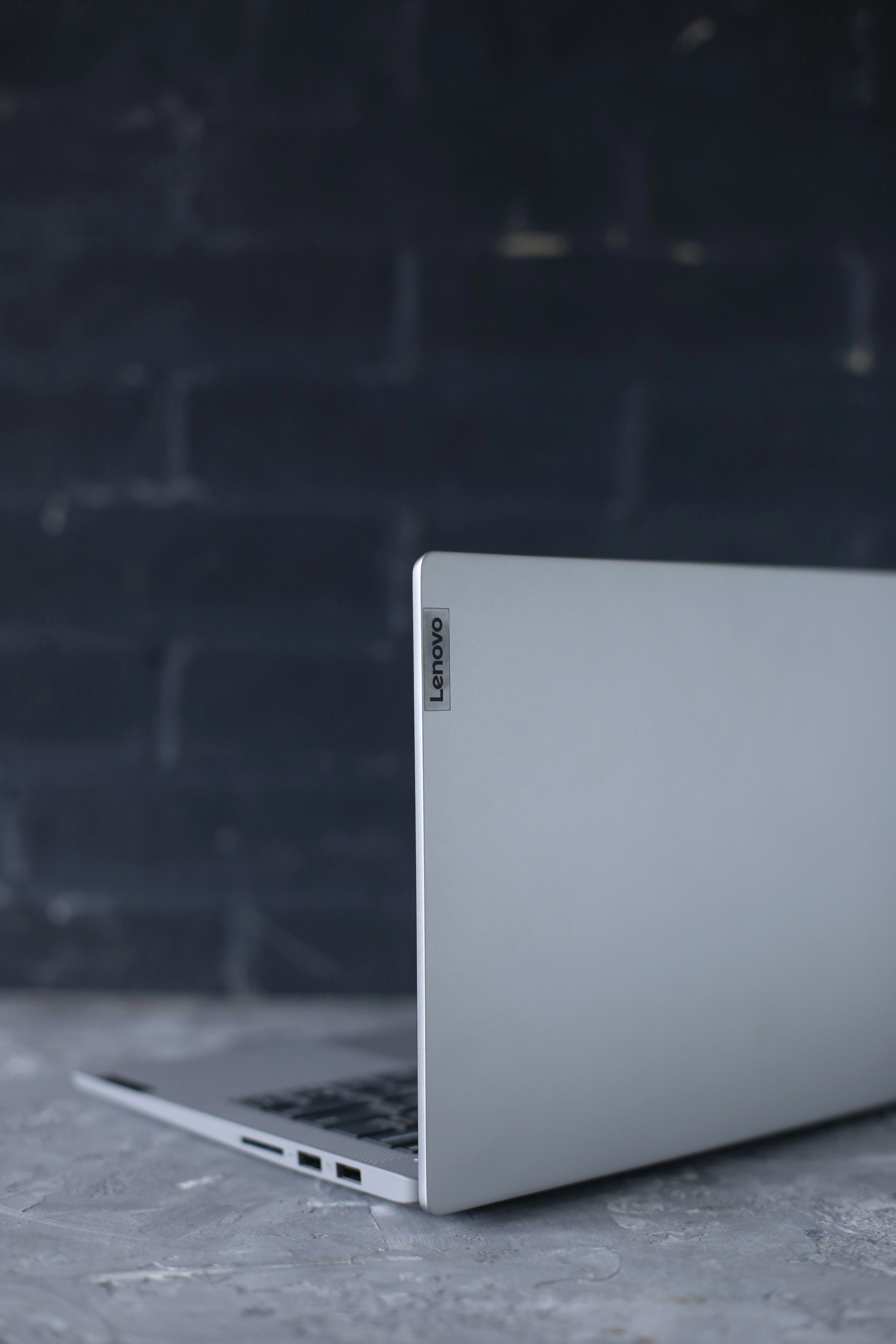 silver macbook on black table
