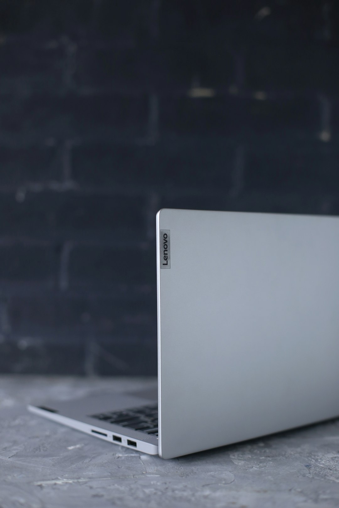 silver macbook on black table