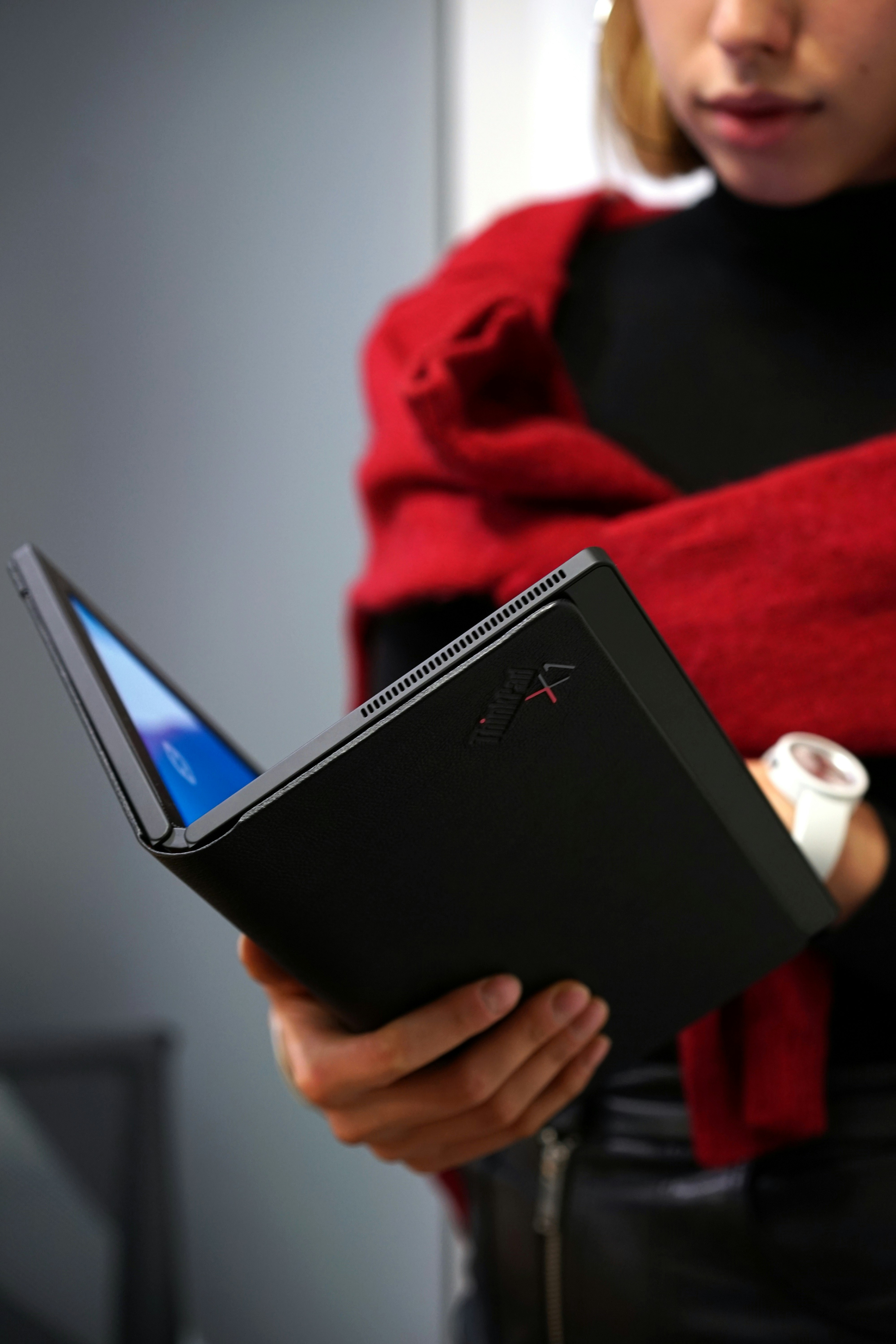 person holding black lenovo laptop