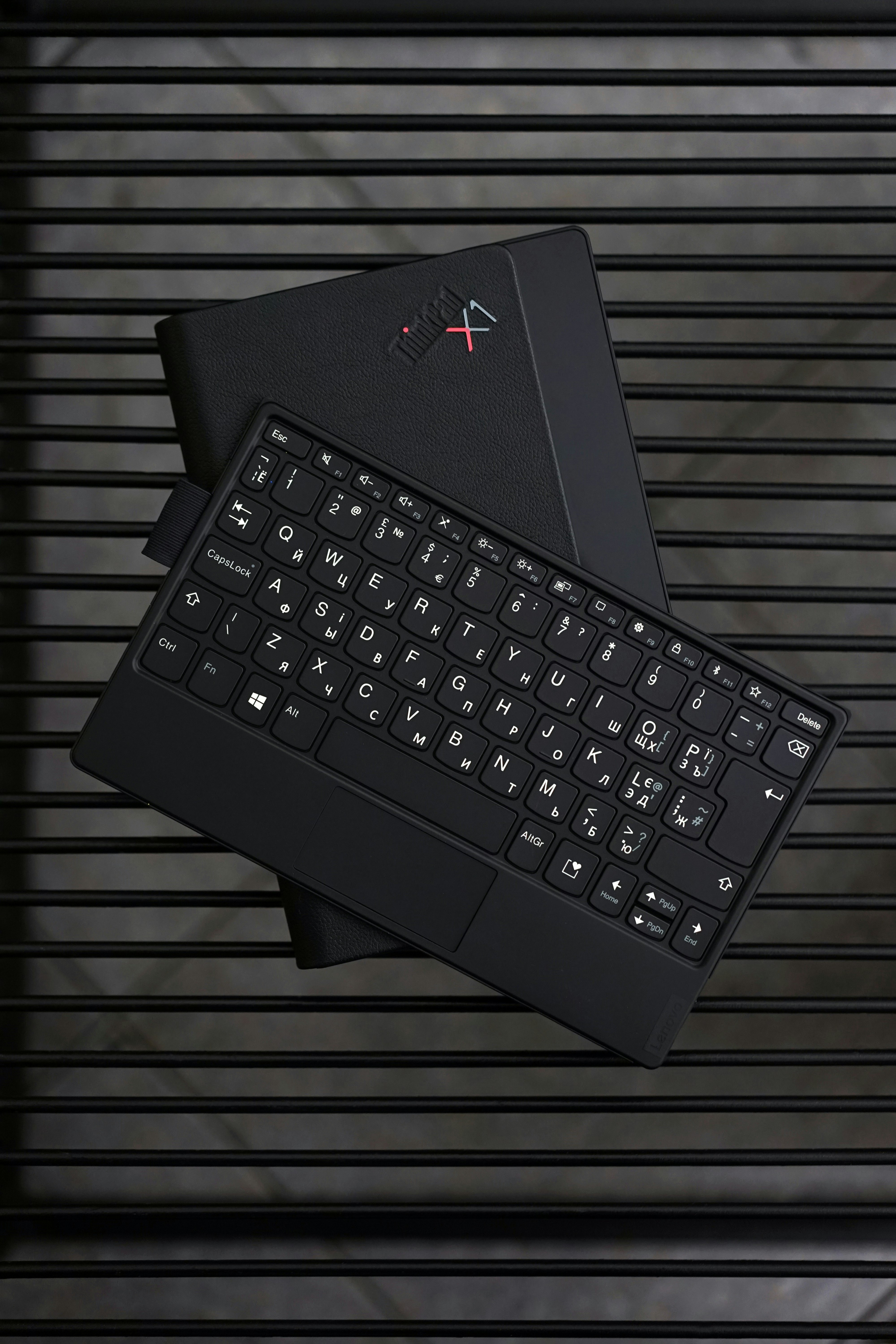 black computer keyboard on white and black stripe textile
