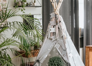 white hammock near green palm plant