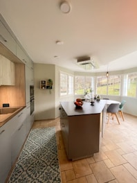 brown wooden kitchen cabinet near white wooden table