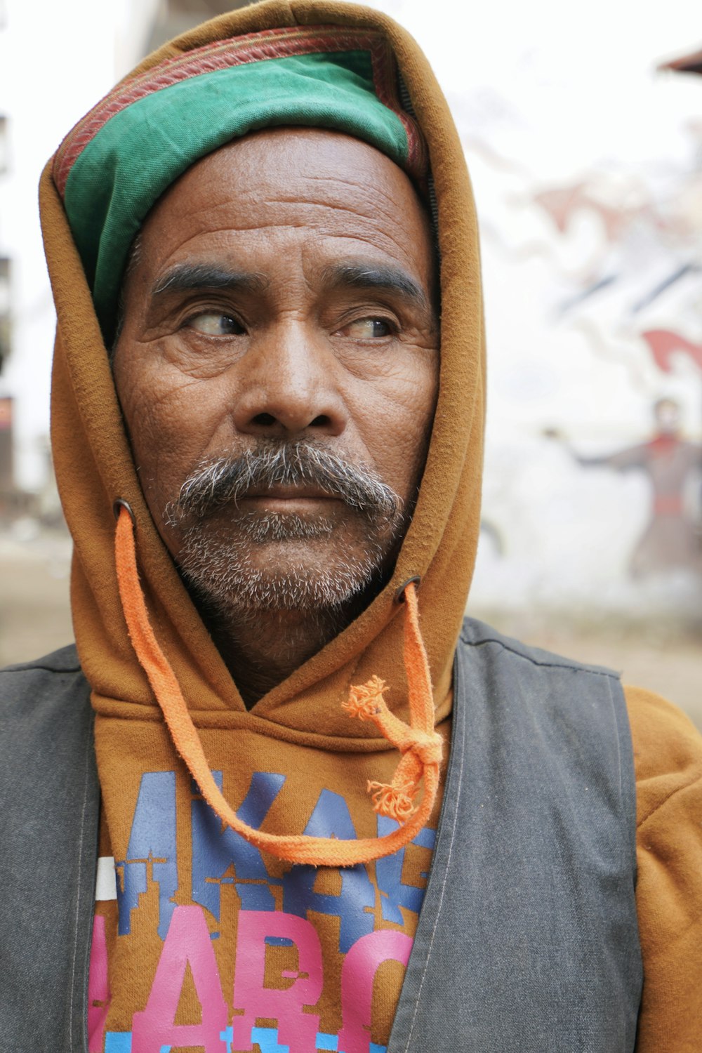 man in orange and green hijab