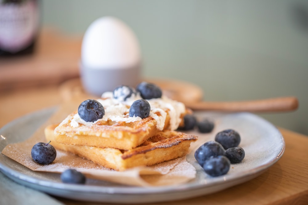 pancakes with blue berries on white ceramic plate