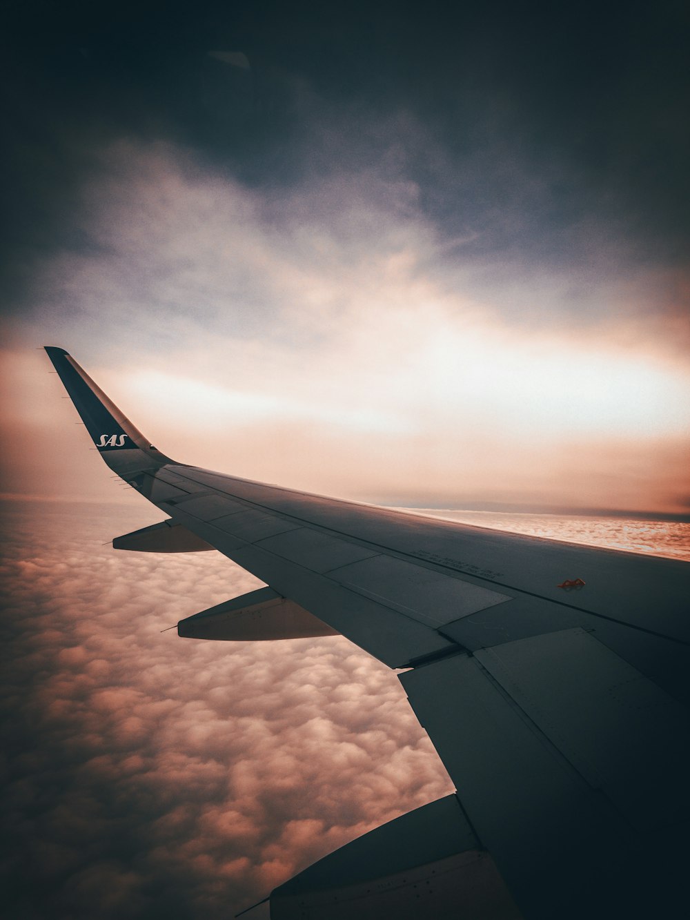 white airplane wing during sunset