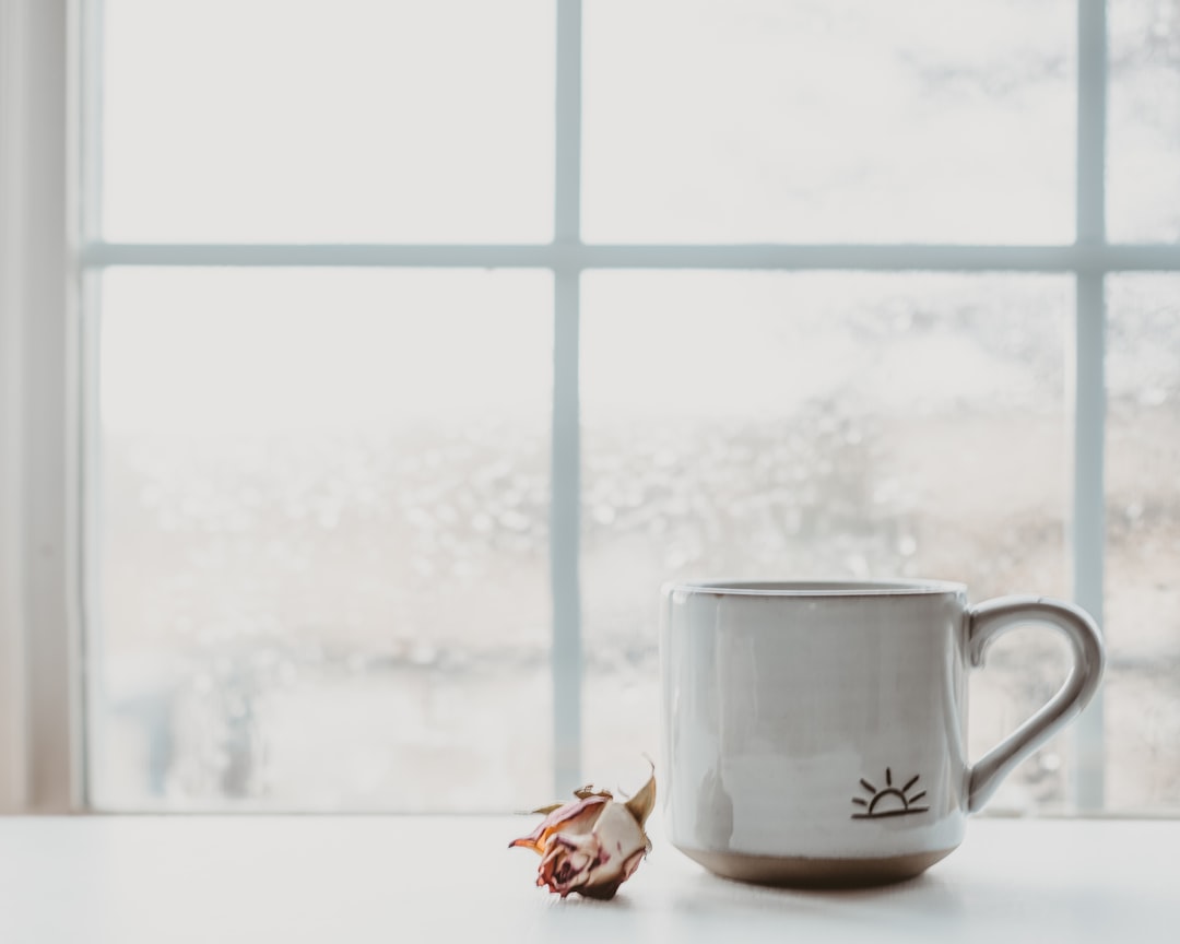 white ceramic mug on white table,