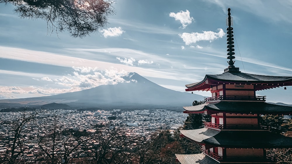 red and white building near body of water under white clouds and blue sky during daytime