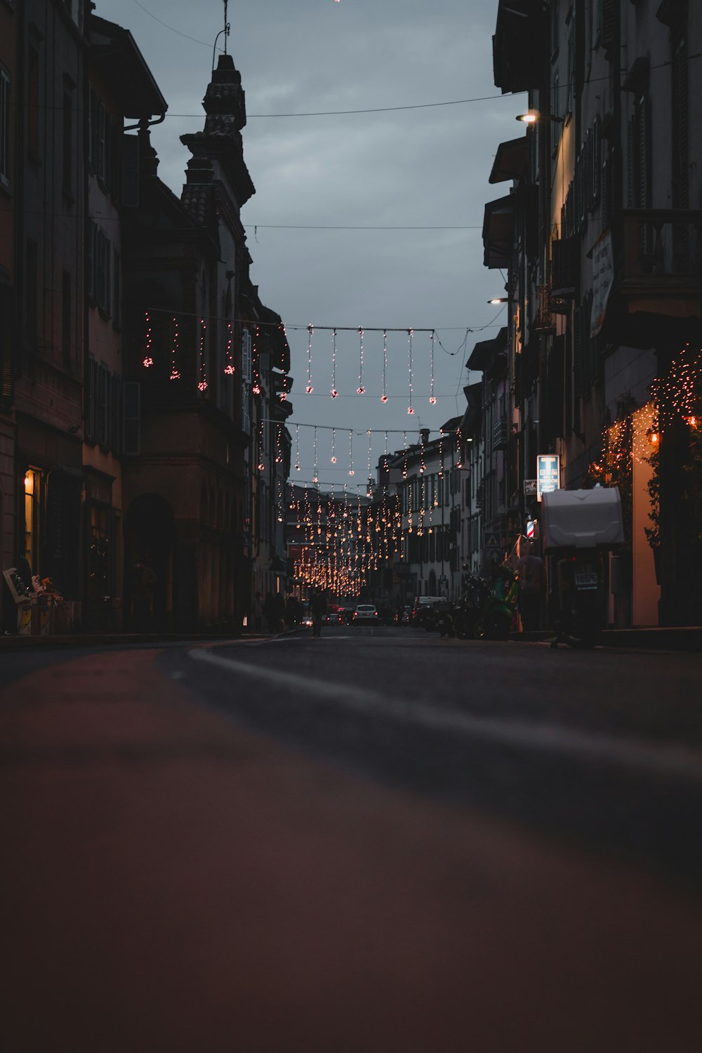 black car on road between buildings during night time