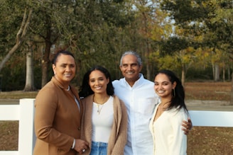 3 women standing near green trees during daytime