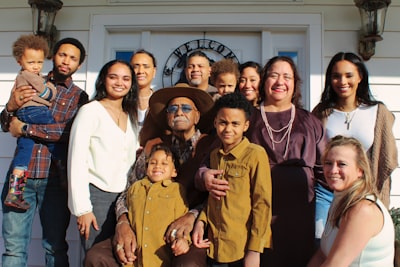 group of people standing near white wall family reunion zoom background