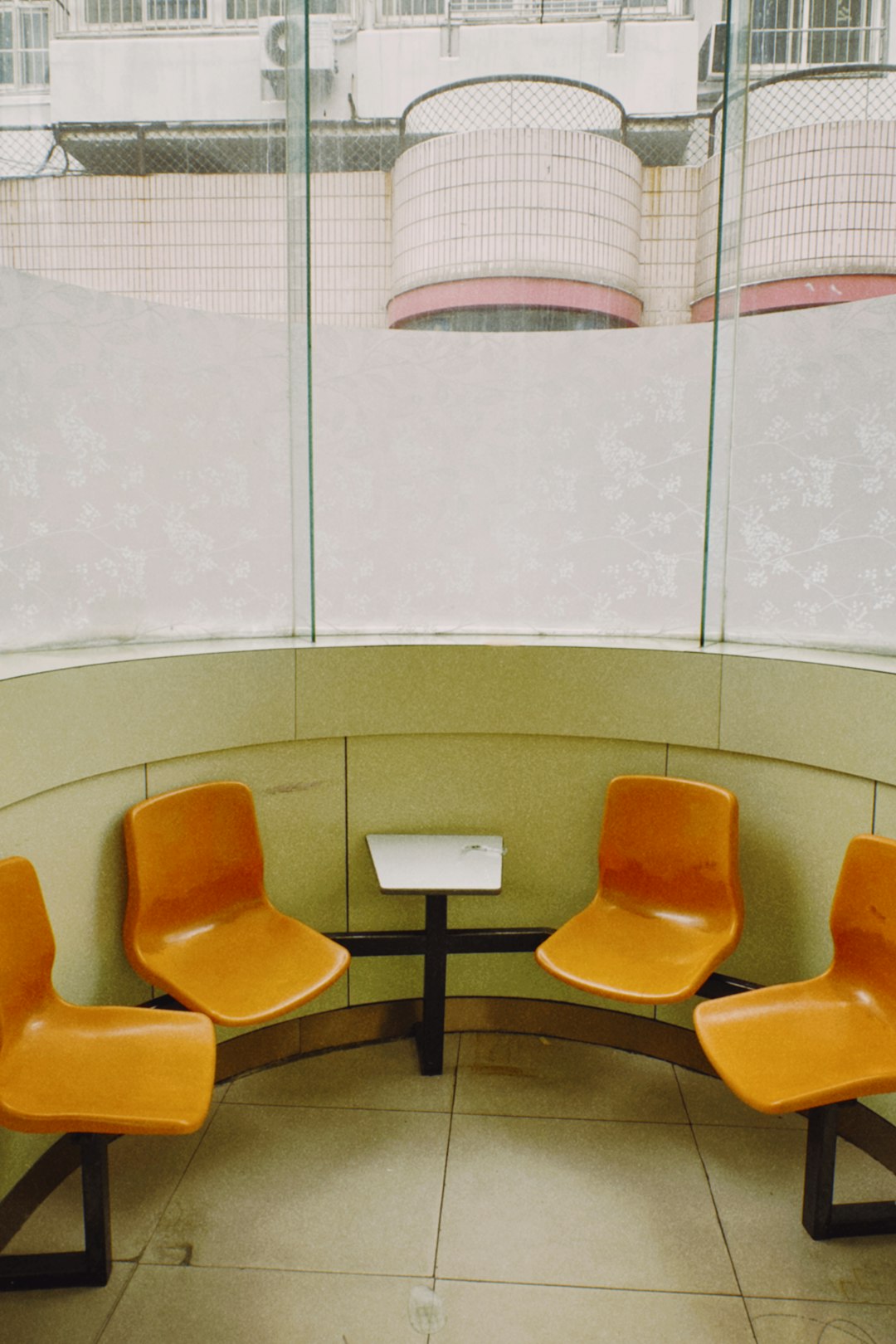 orange and black chairs near white wall