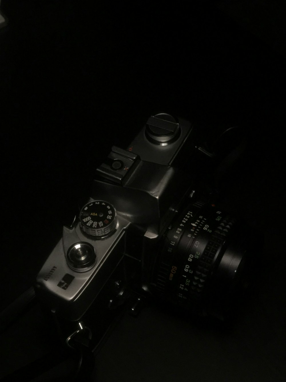 black dslr camera on black surface