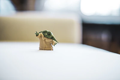 Soft pastel green 3D figurine with intricate details and a matte finish.