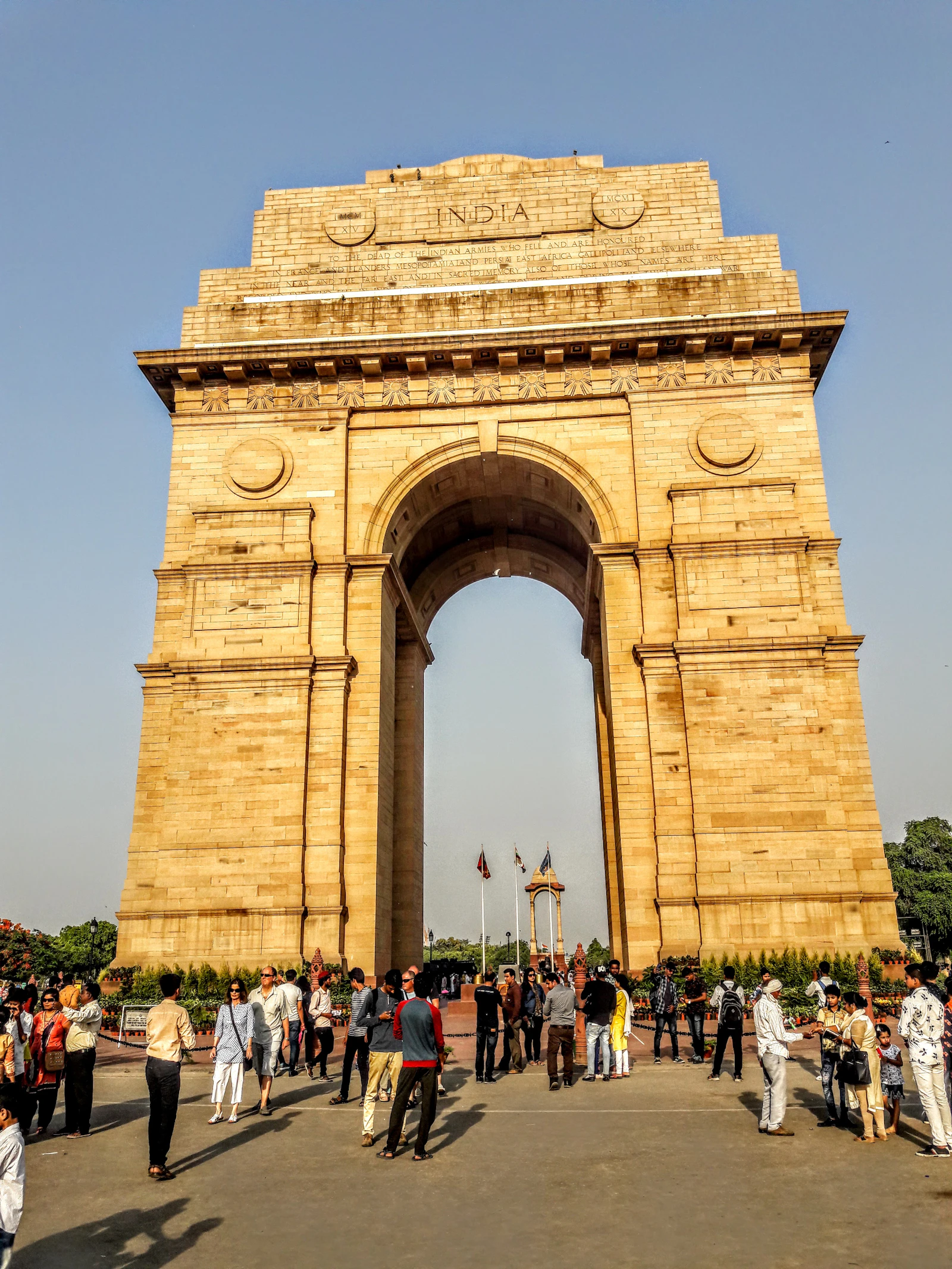 India Gate arch with people walking, central Delhi