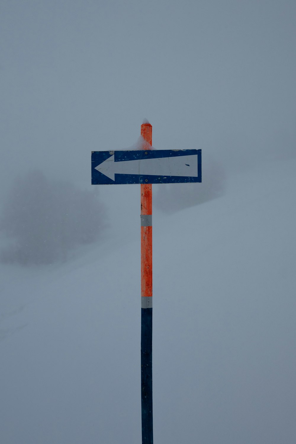 blue and white arrow sign