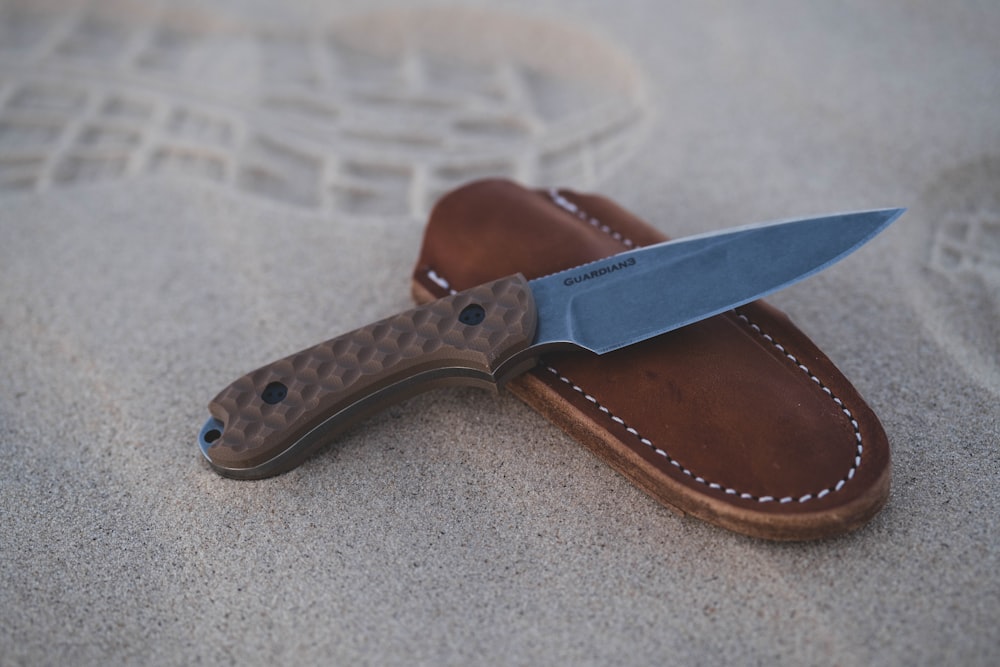 brown and silver folding knife