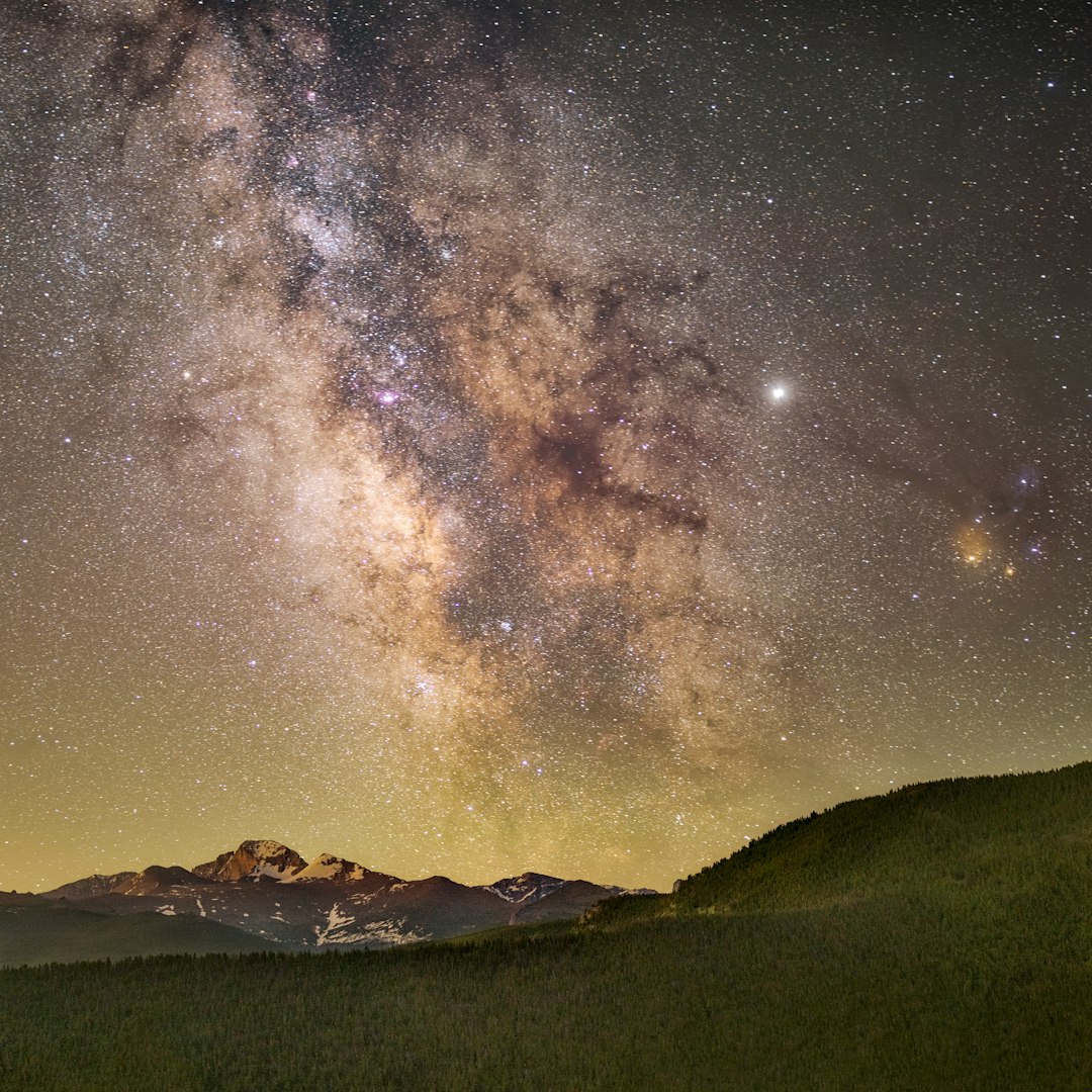 green mountains under starry night