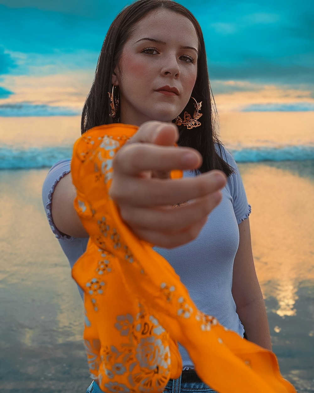 woman in yellow and white polka dot long sleeve shirt holding her chin