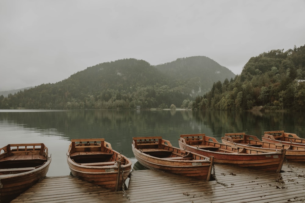 brown wooden boats on lake during daytime