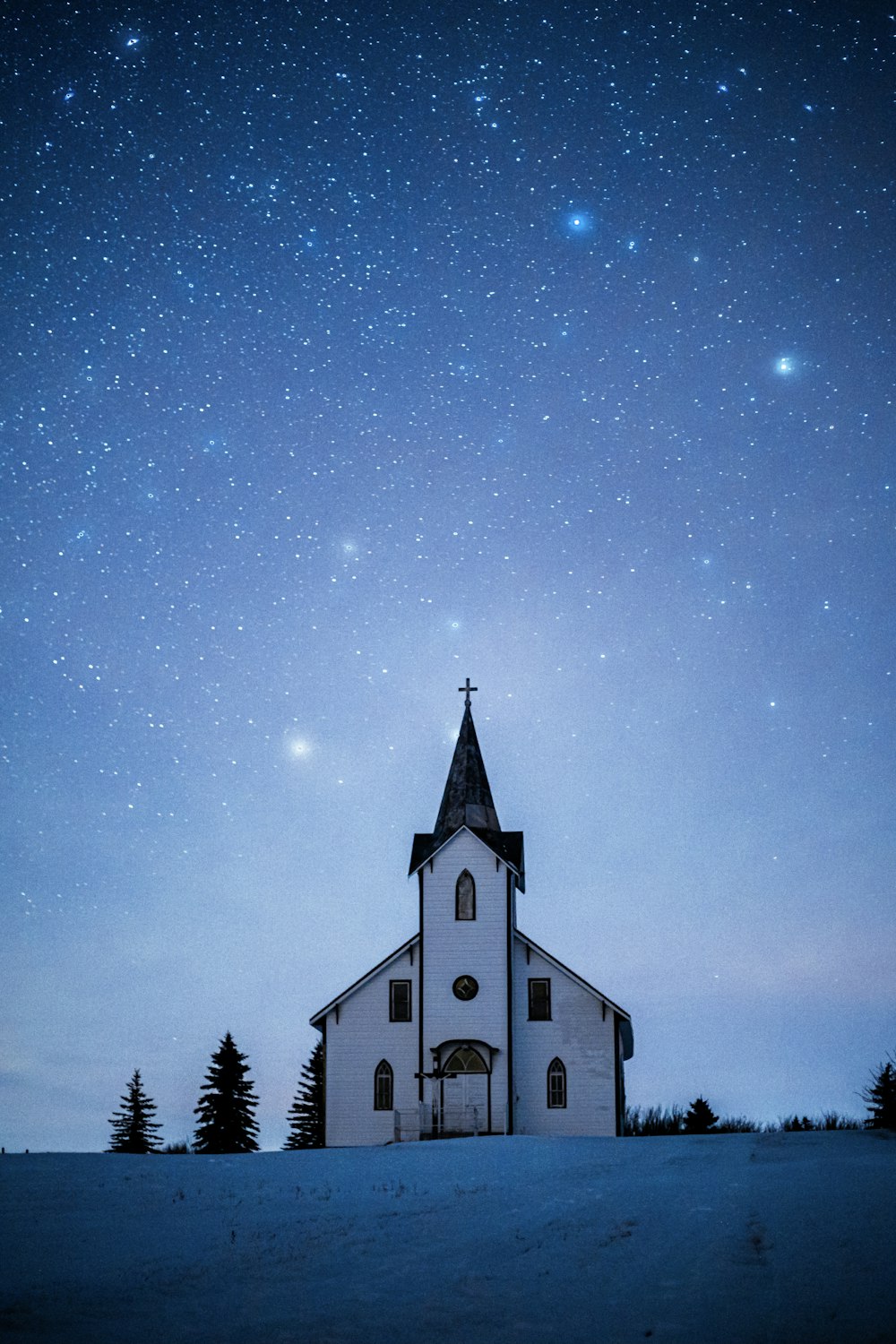 white and black church under blue sky