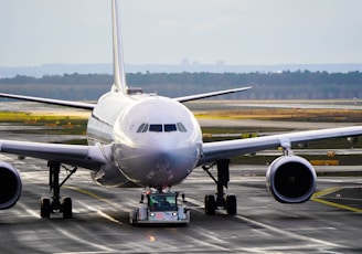 white and blue airplane on airport during daytime