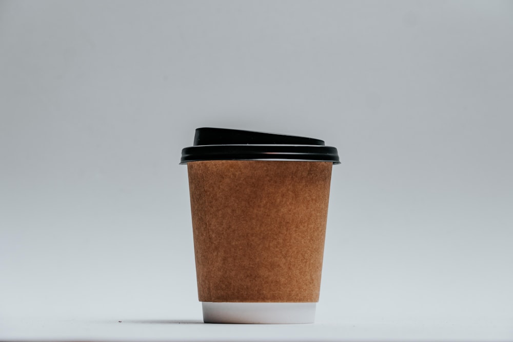 brown and black paper cup