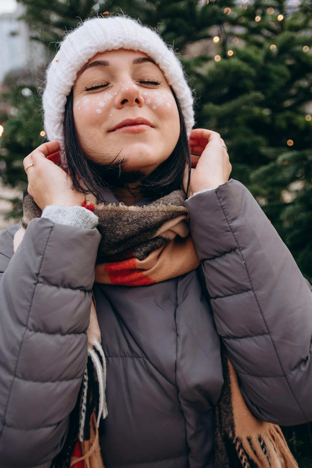 woman in black jacket and white knit cap