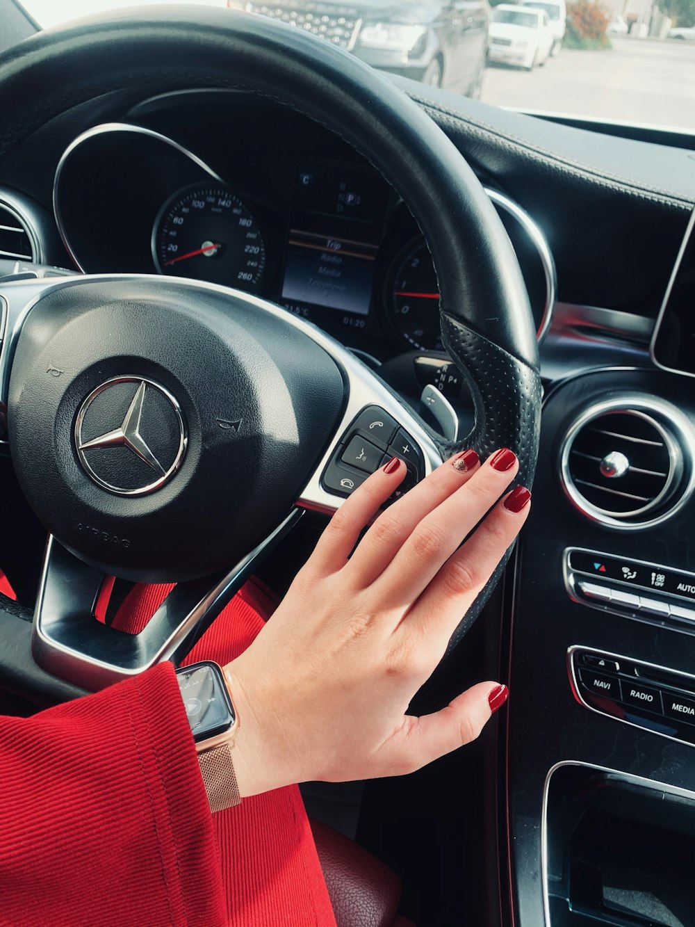 person holding black mercedes benz steering wheel